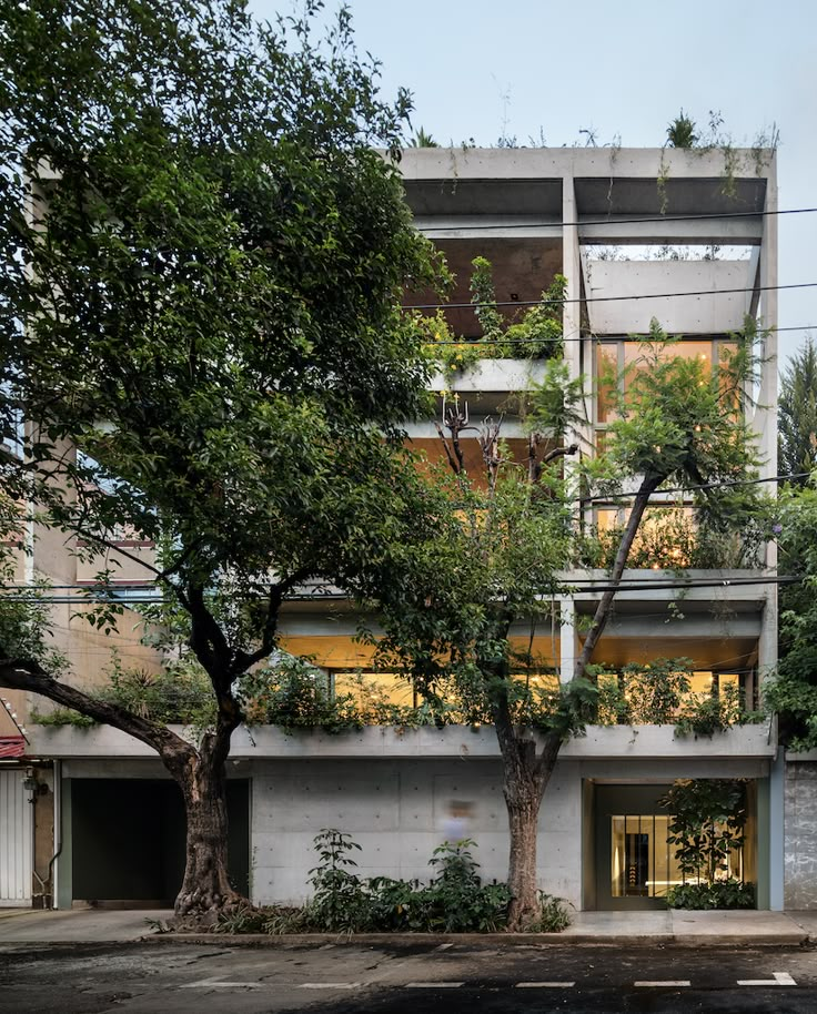 an apartment building with trees in front of it