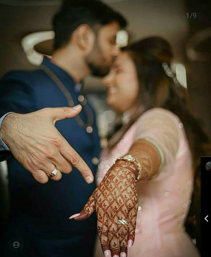 a bride and groom holding their hands out to each other