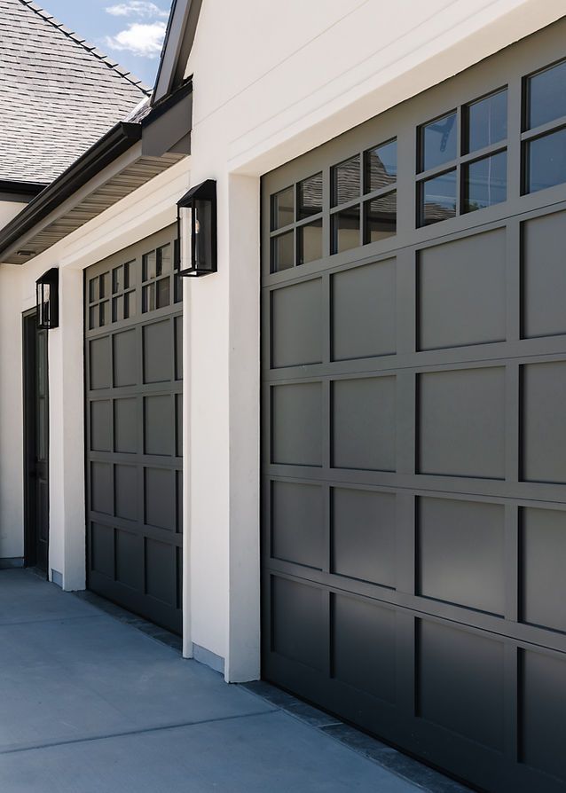 two garage doors on the side of a house