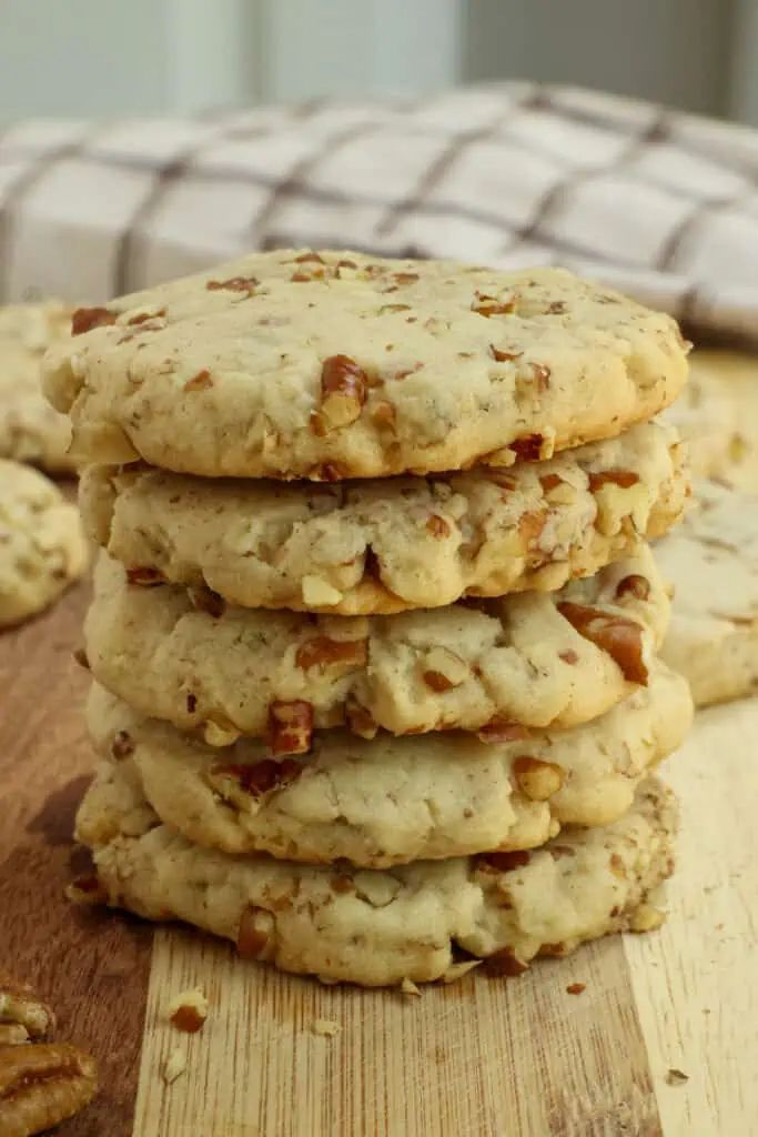 a stack of cookies sitting on top of a wooden cutting board