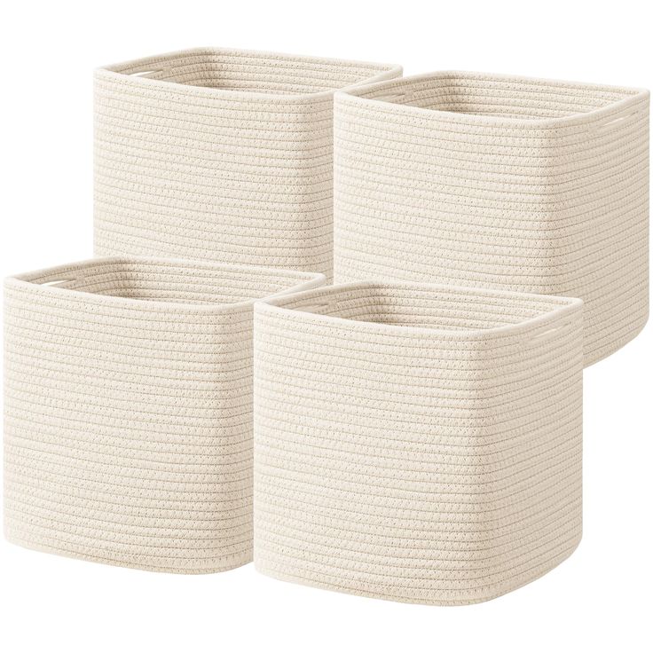 three white baskets with handles on each side