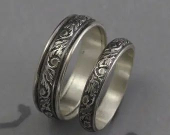 two silver rings with filigrees on them