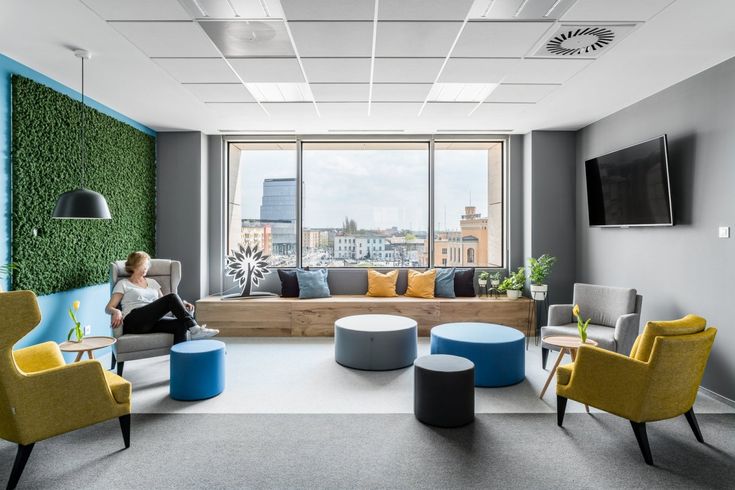 a woman sitting on a couch in an office