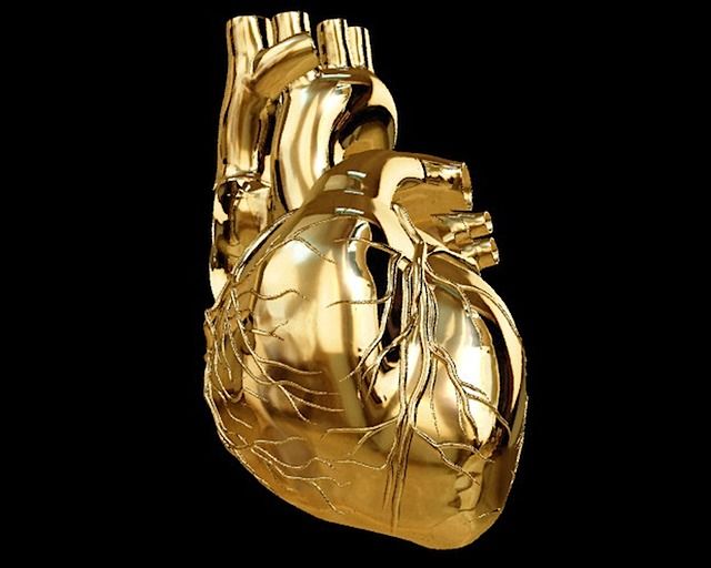 a golden heart shaped object on a black background