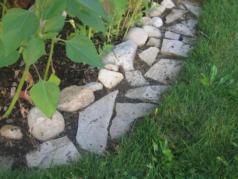 there is a rock garden bed in the grass