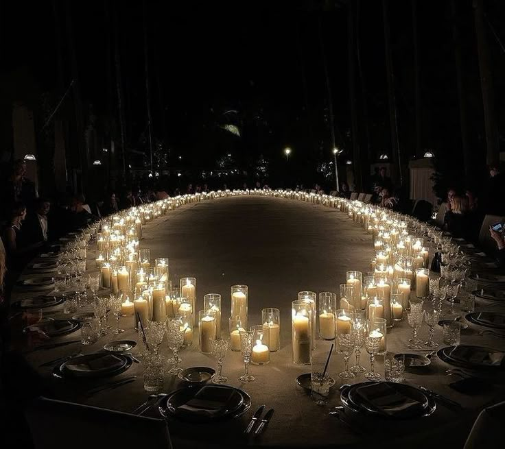 a circular table with many lit candles on it