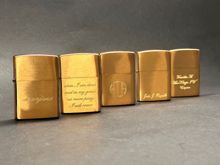 four different types of gold colored lighters with writing on the front and back sides