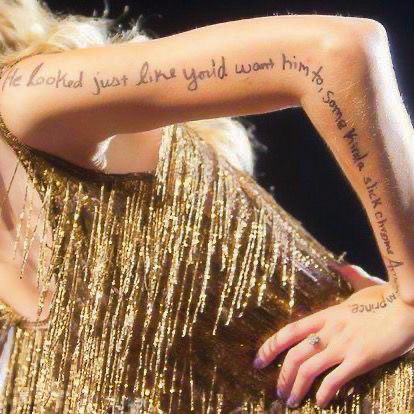 the back of a woman's arm with words on it and writing on her chest