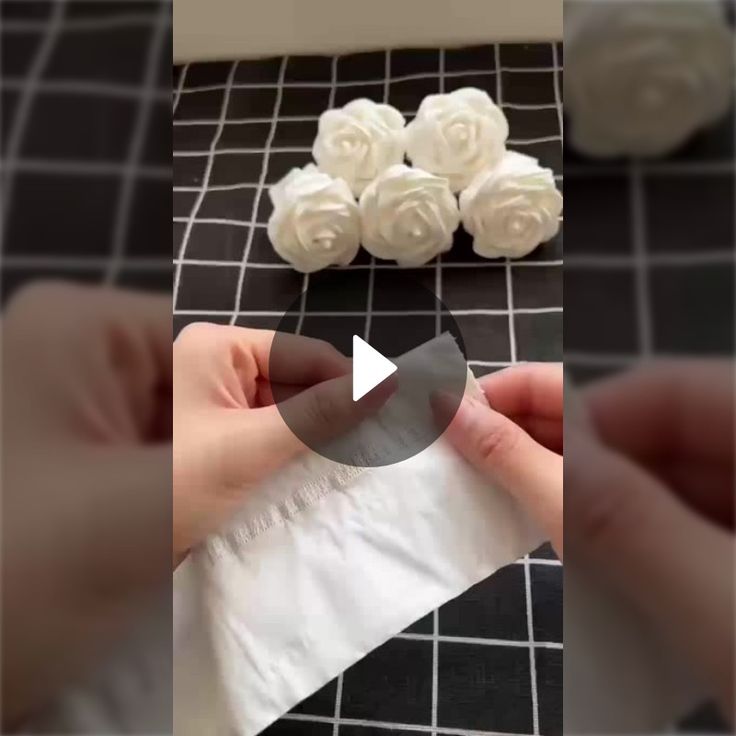 the video shows how to make fake flowers out of toilet paper and napkins with scissors