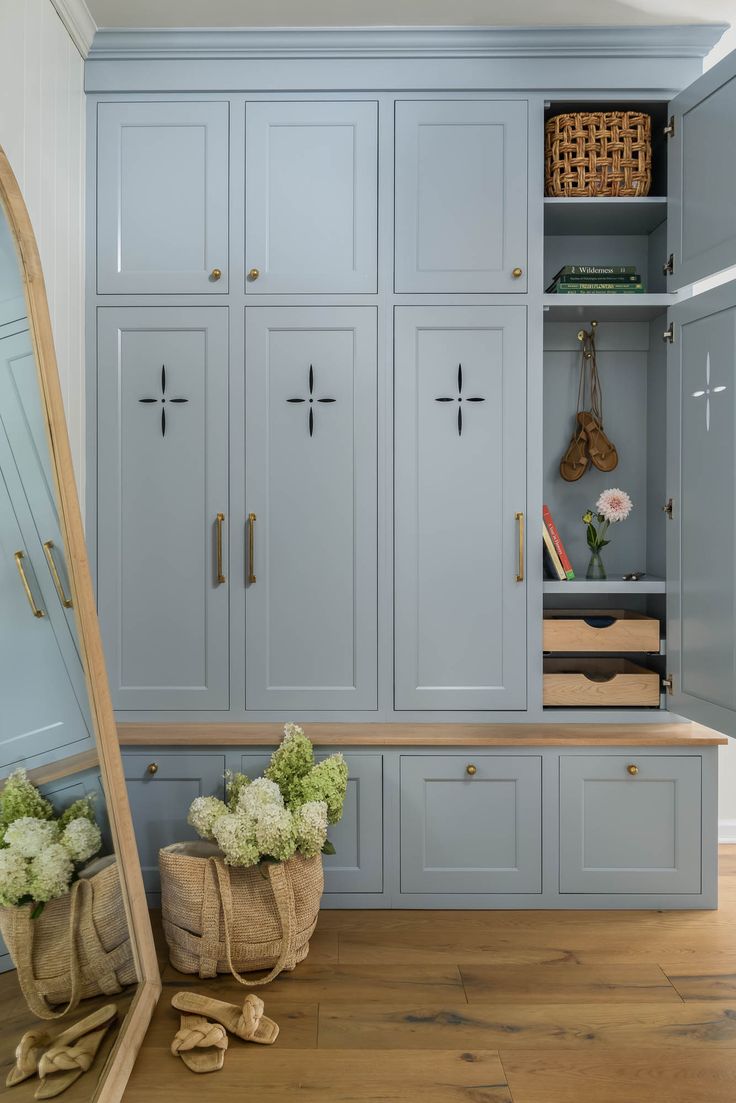 an empty room with blue cabinets and flowers