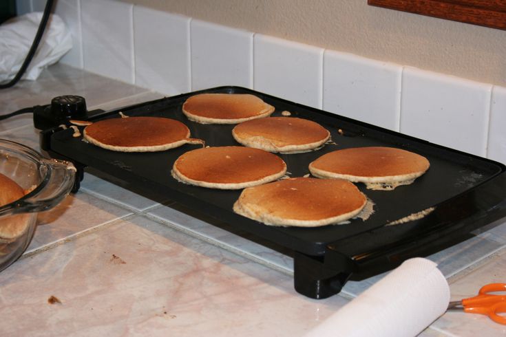 some pancakes are sitting on a black tray