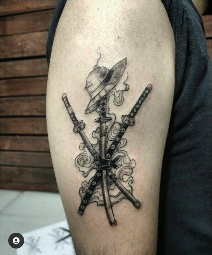 a man with a tattoo on his arm has two swords in the middle of it