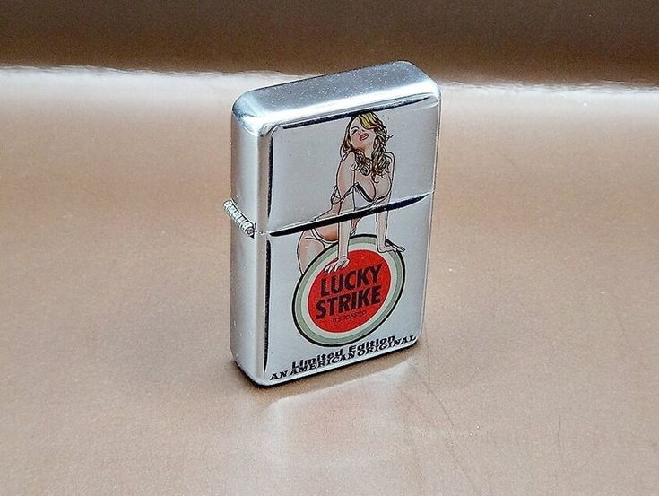 a lighter that is sitting on top of a table with a sticker on it