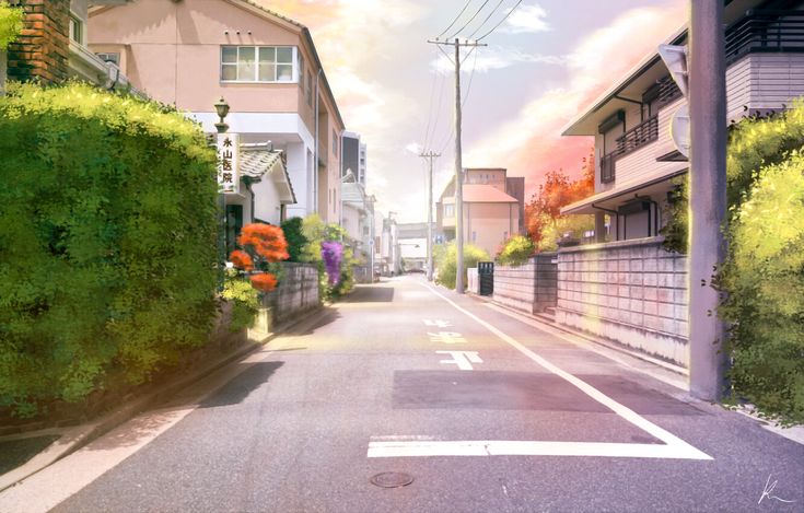 an empty street lined with houses and trees