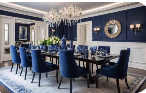 a dining room with blue chairs and a chandelier