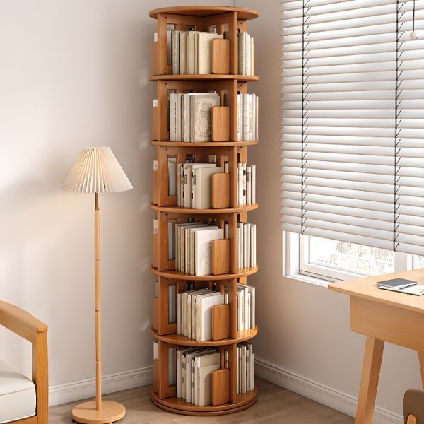 a corner book shelf with many books on it next to a chair and table in front of a window