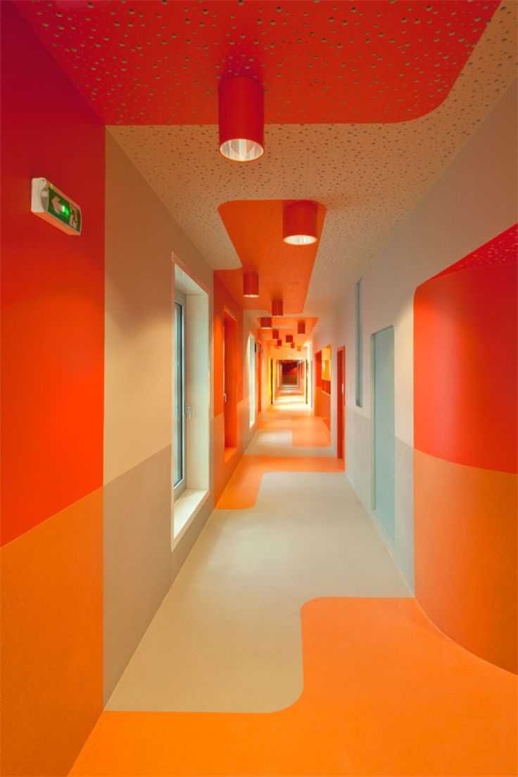 an orange and white hallway is shown in this image, with bright colors on the walls