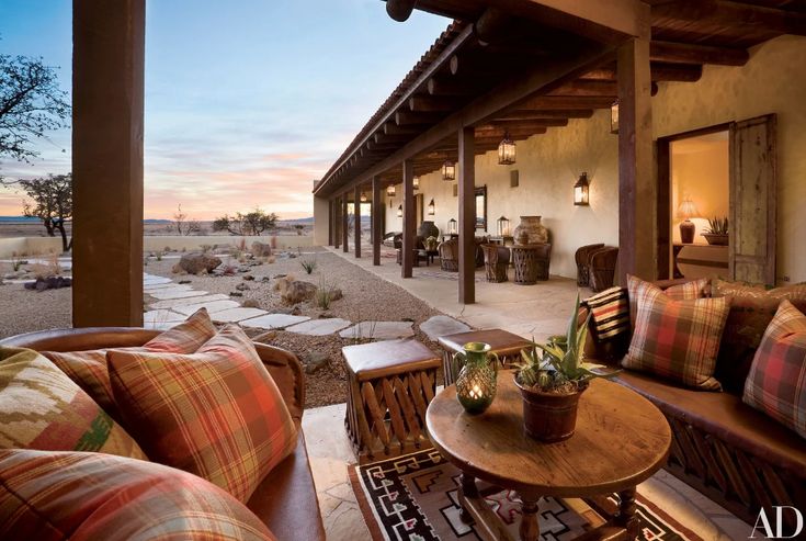 an outdoor living area with couches and tables