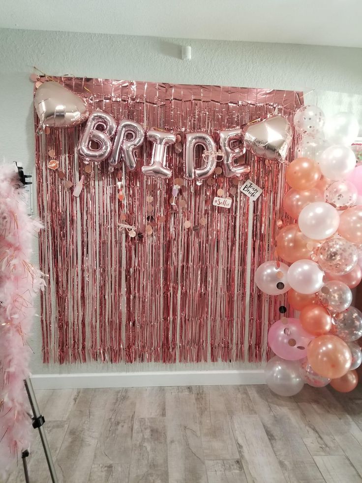 balloons and streamers decorate the entrance to a bride's bridal party in pink