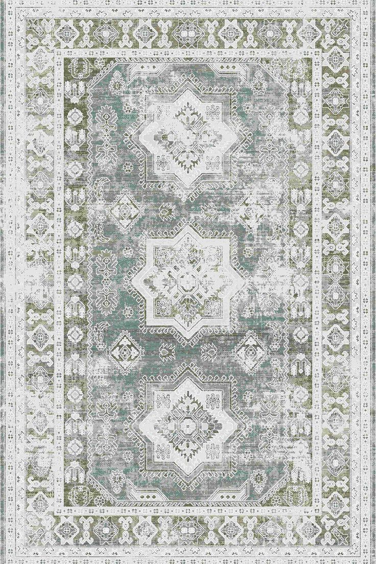 a green and white rug with an ornate design on the bottom, in various colors