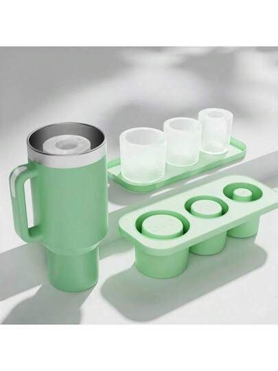 an ice tray with four cups and one mug on it, sitting next to each other