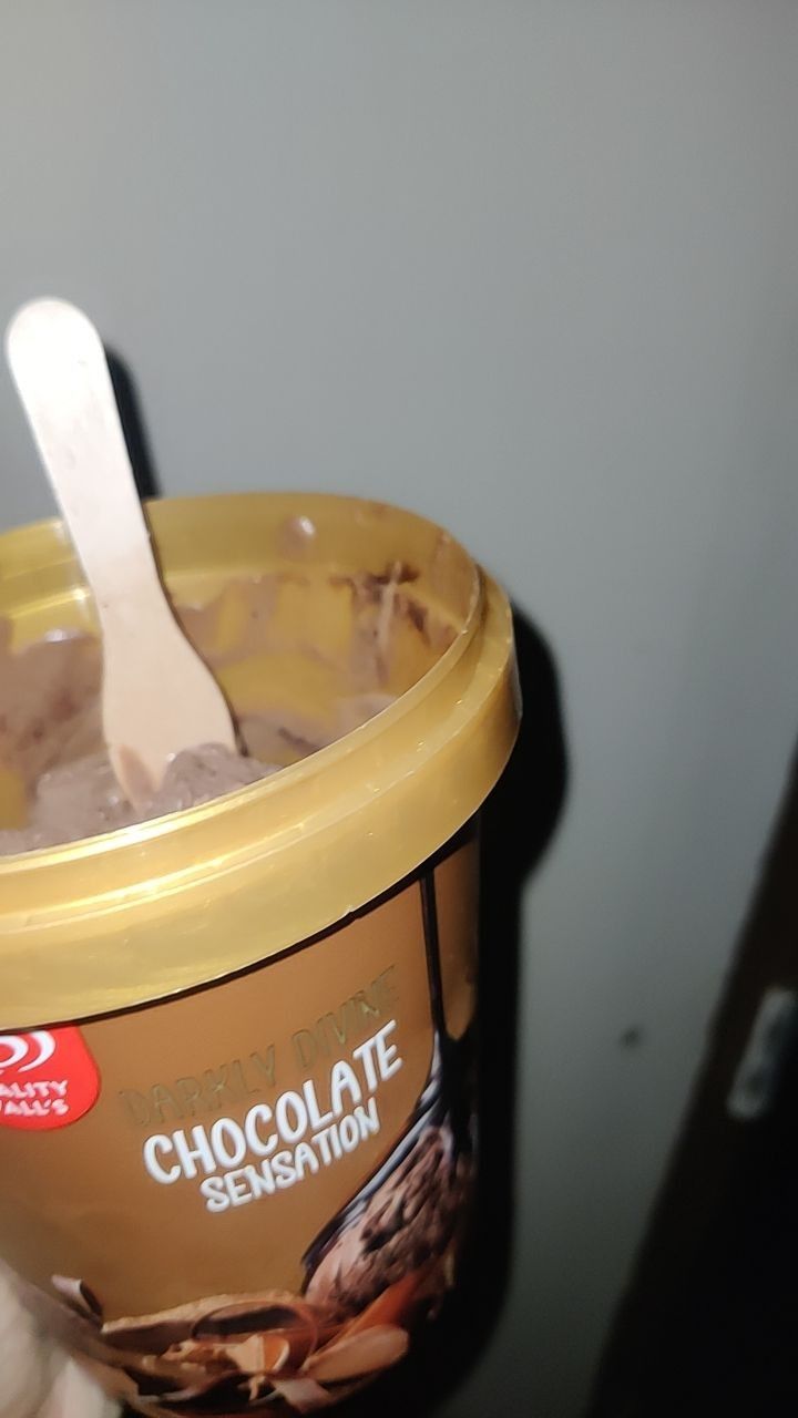 an ice cream container filled with chocolate and nuts