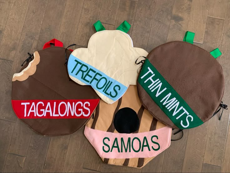 three hats are sitting on the floor with name tags attached to them, and one hat has been made from fabric