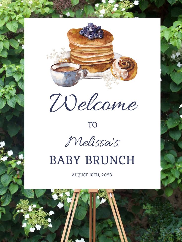 a welcome sign for a baby brunch with blueberries and pancakes on it