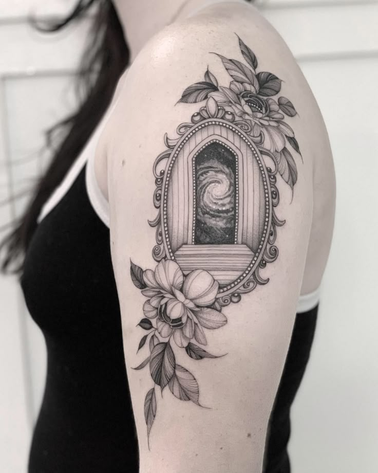 a woman with a tattoo on her arm has a frame and flowers around it that is in the shape of a mirror