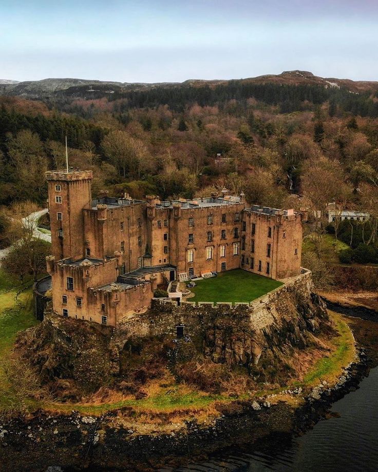 an old castle sits on top of a small island