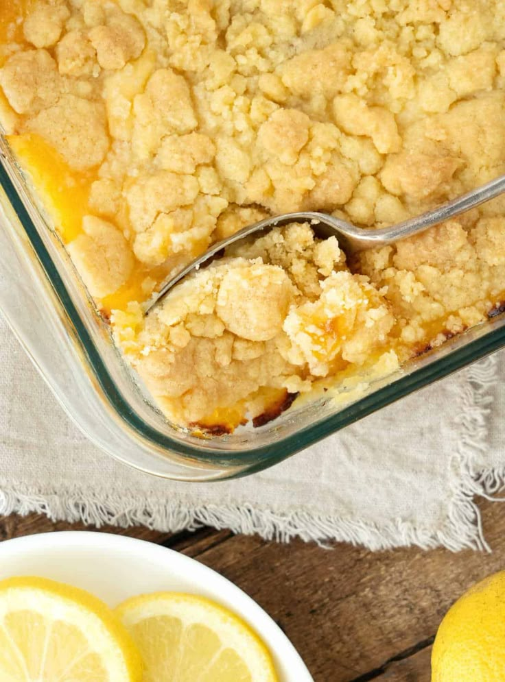 a dish of lemon cobbler with a spoon in it