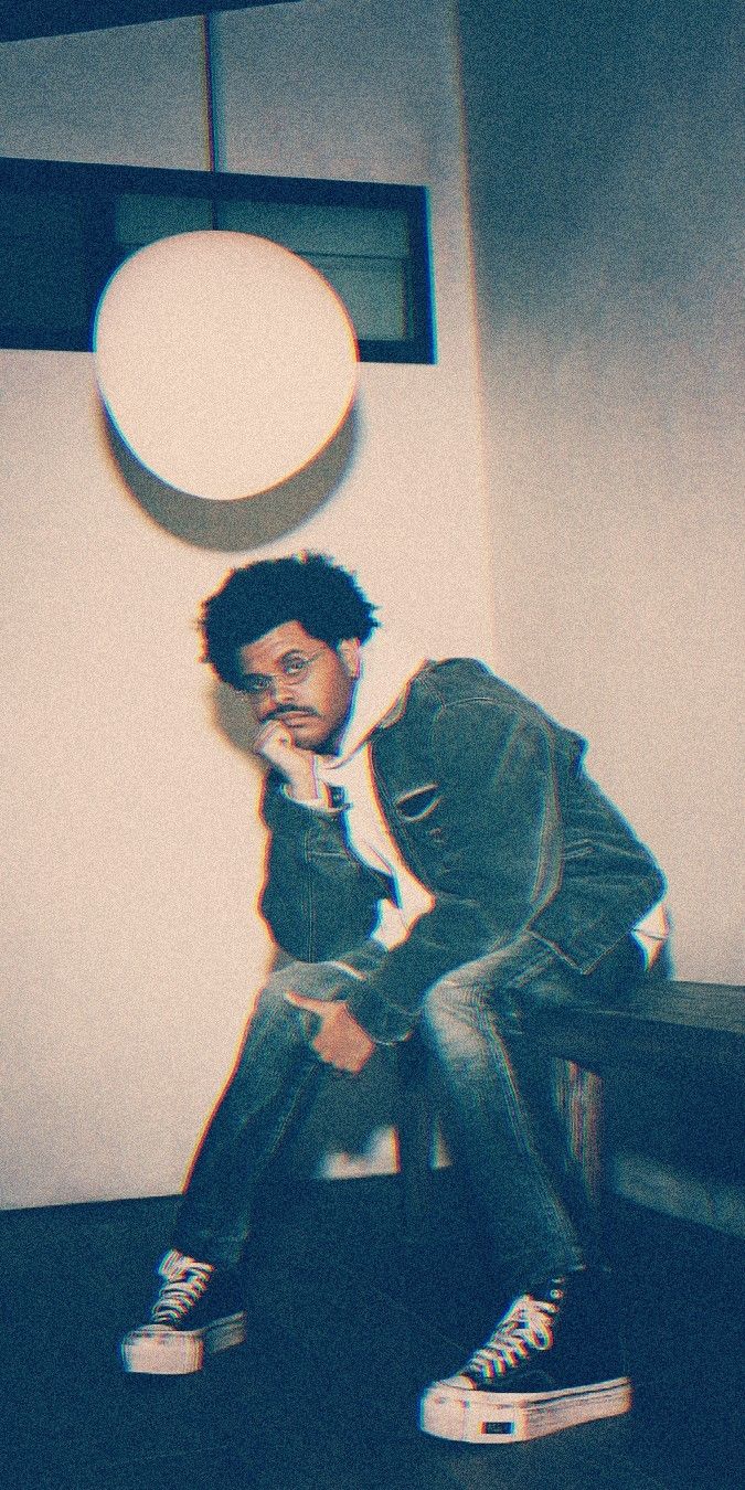 a man sitting on top of a chair next to a white frisbee