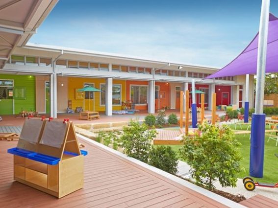 an outdoor play area with toys and tables