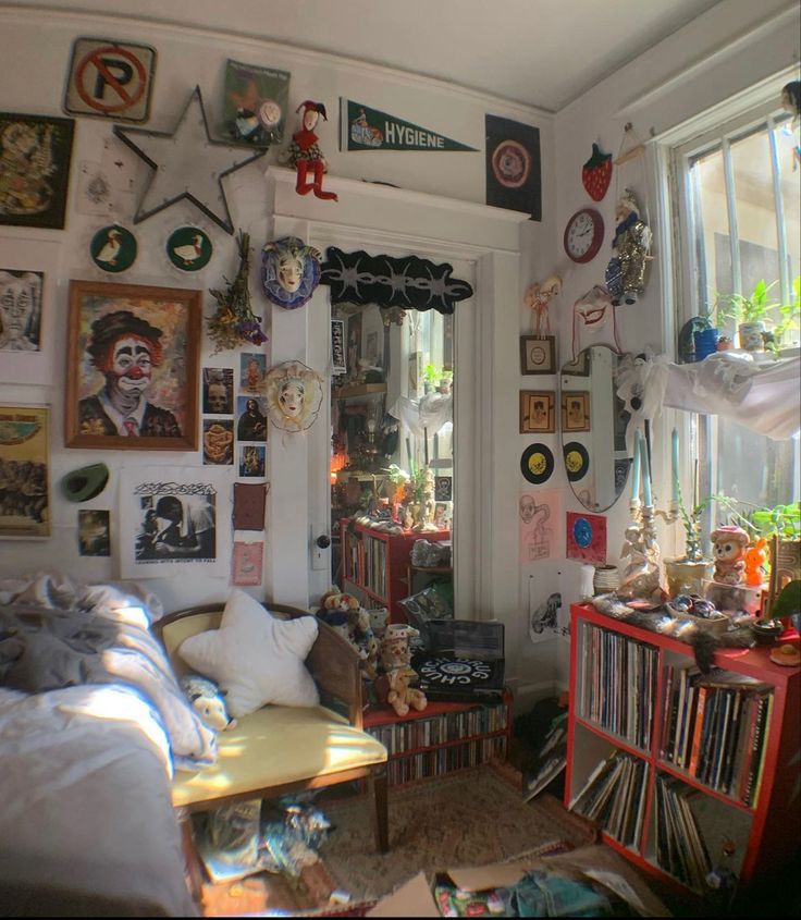 a living room filled with lots of clutter and pictures on the wall above it