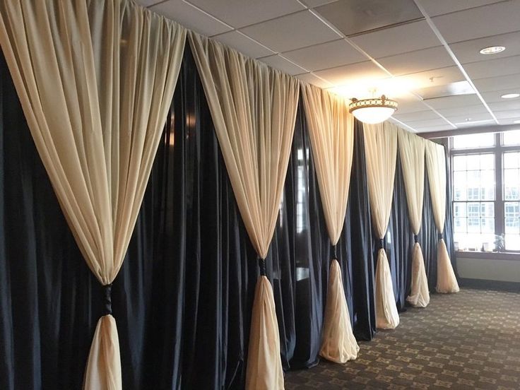 an empty room with black and white drapes