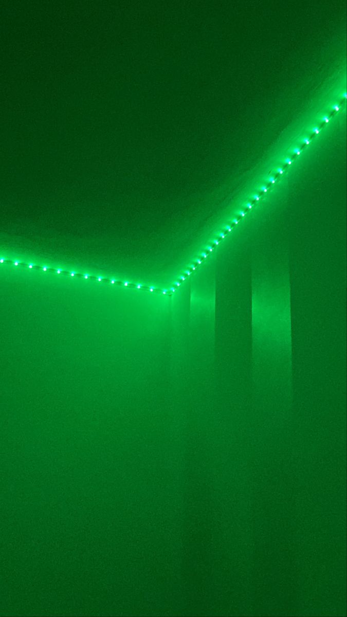 a green room with some lights on the ceiling