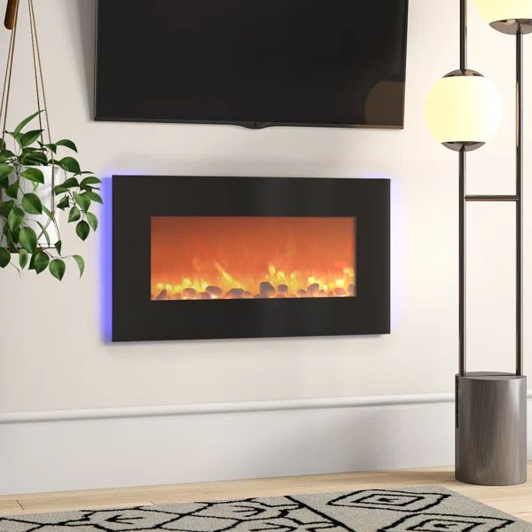 a living room with a large television mounted on the wall and a fire in the fireplace