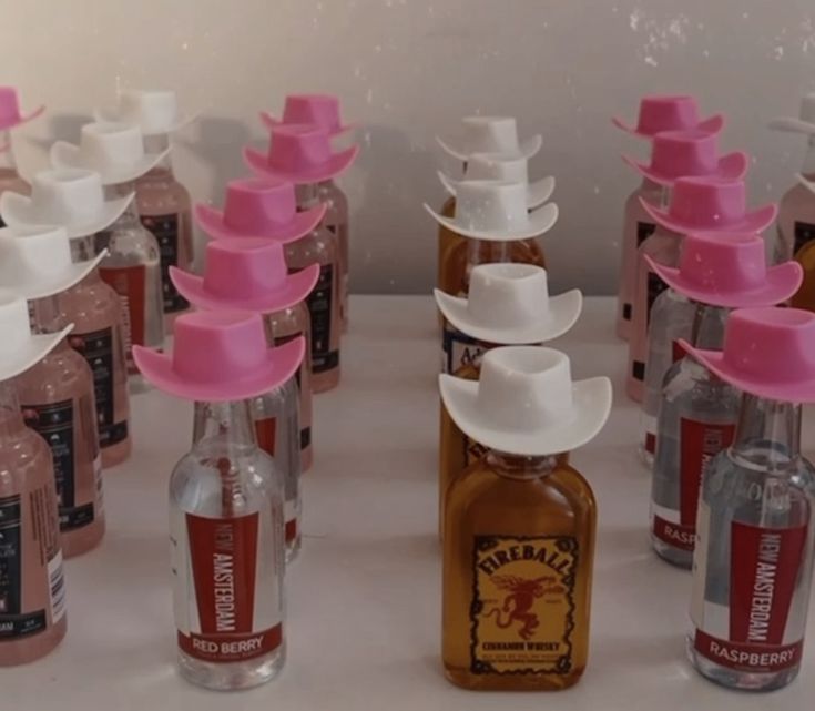 several bottles with hats on them sitting next to each other