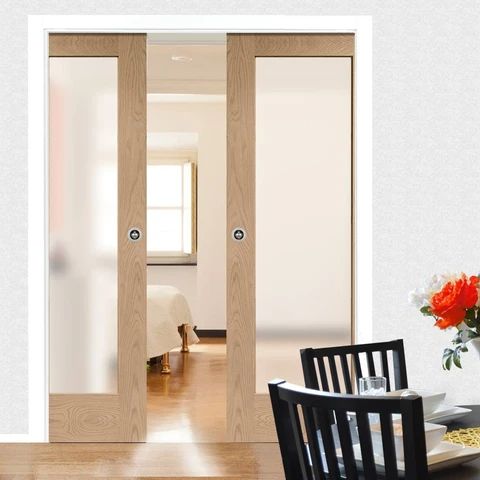 an open door leading to a bedroom and dining room with flowers in the vase on the table