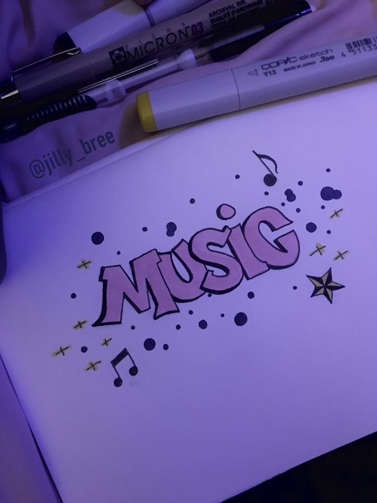 a notepad with the word music written on it next to some markers and pens