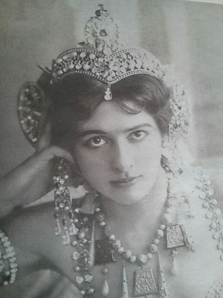 an old black and white photo of a woman wearing a tiara