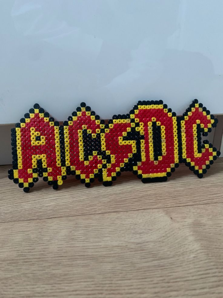 Logo from the band called ACDC iron on beads ideas Perler Bead Band Logos, Rock Perler Beads, Band Perler Beads, Iron On Beads Ideas, Peeler Beads Patterns Easy, Melty Beads Ideas, Perleplader Ideas, Ironing Beads, Hamma Beads Ideas