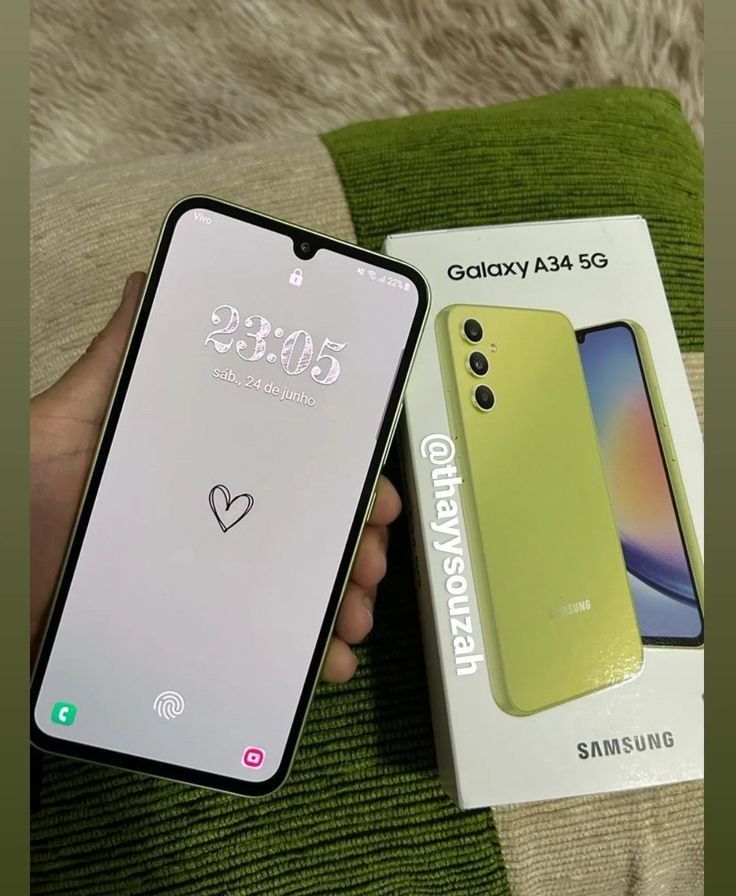 someone is holding their new samsung galaxy a50s in its box and it's already out