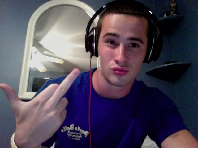 a young man wearing headphones and making the peace sign