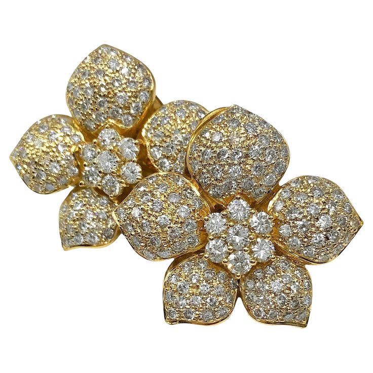 This lovely late-20th Century pair of 18k yellow gold and diamond, flower motif earrings is heavily pave set with round brilliant cut diamonds with 5.25Ct total approximate weight of overall H color and VS2 clarity. Equipped with posts and "monster backs". With a maximum diameter of 1 1/4 inches and with every surface covered with diamonds, this pair have a striking and scintillating presence. Earrings are not signed but do test as 18K and each back is signed 18k and with the manufacturers name Luxury Flower Shaped Diamond Earrings With Accents, Luxury Flower-shaped Diamond Earrings With Accents, Luxury Flower Shaped Diamond Earrings, Flower Motif, Flower Tops, Diamond Flower, Antique Diamond, Vintage Diamond, Round Brilliant Cut Diamond