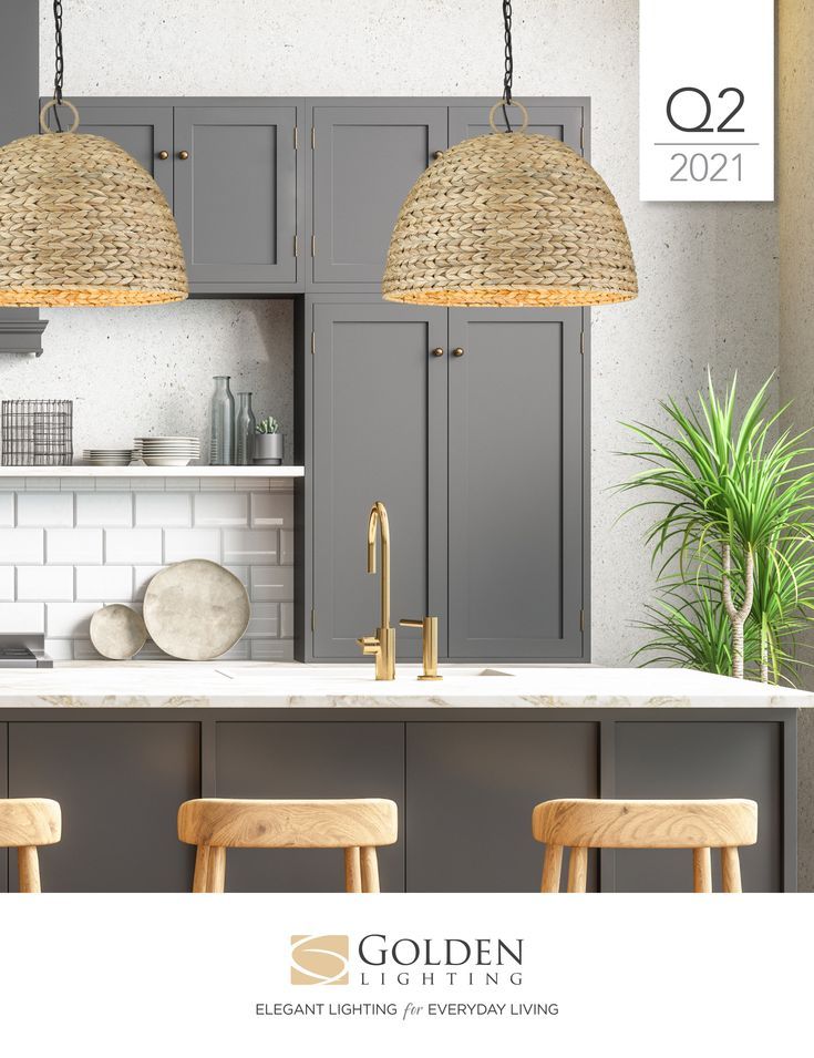 an image of a kitchen with grey cabinets and white counter tops, gold accents on the pendant lights