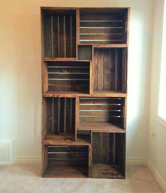 a bookcase made out of wooden crates in a room