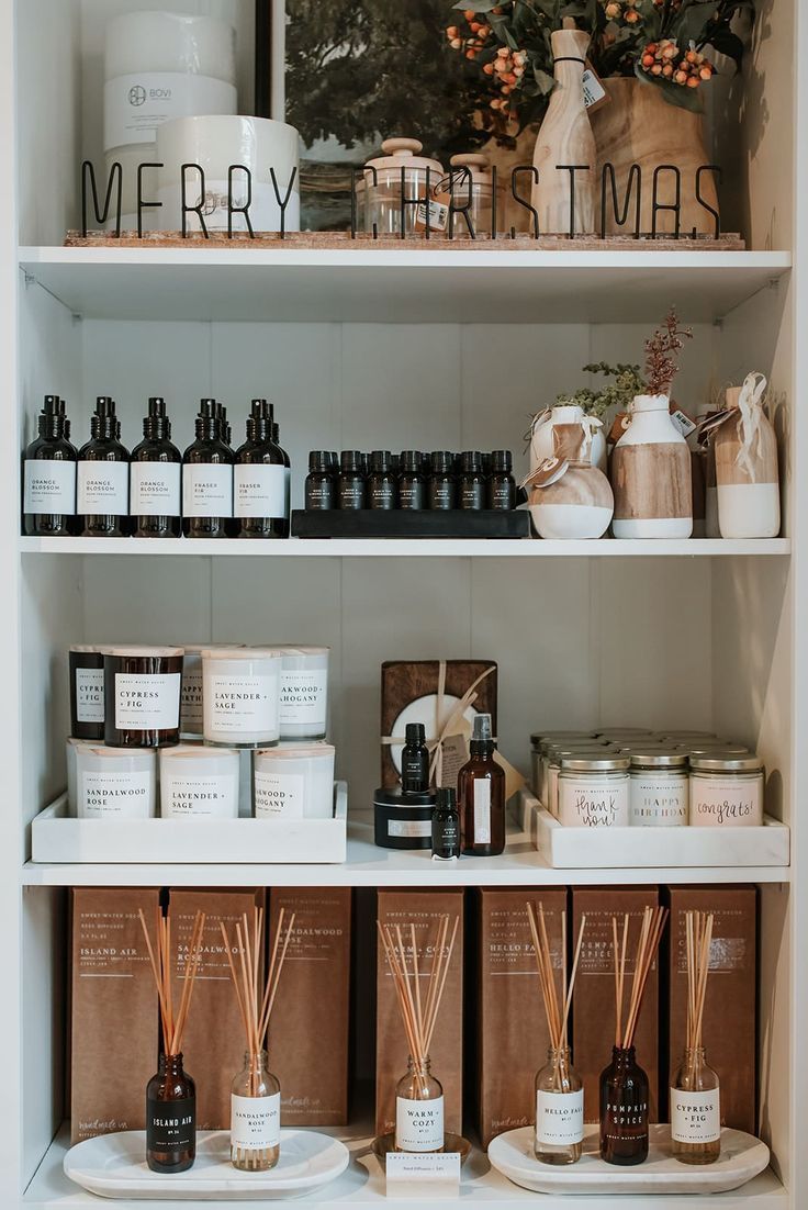 the shelves are filled with various types of christmas candles and body care products for sale