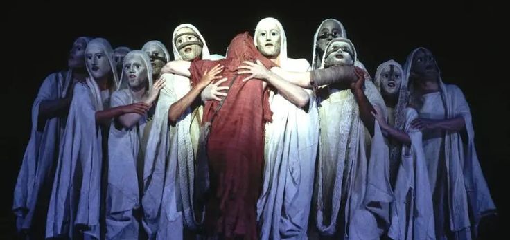 a group of people standing next to each other in front of a black background with white heads