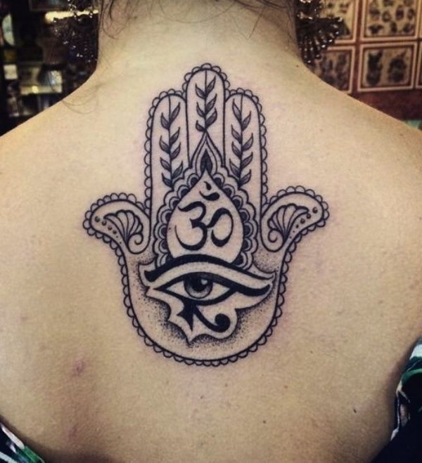 a hamsa tattoo on the back of a woman's neck